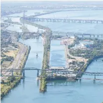  ?? ALLEN MCINNIS ?? A boat sails the St. Lawrence Seaway toward the St. Lambert locks in this aerial photo of Montreal taken last summer.