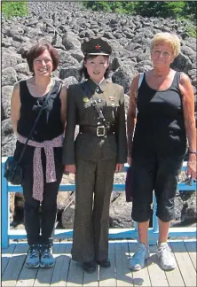  ??  ?? Sight-seeing: Elizabeth Quin (right) with her daughter Stella and their guide, sightseein­g in North Korea