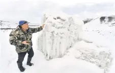  ?? ?? Kaldanov inspects the artificial glacier in a mountain gorge near the village of Syn-Tash.