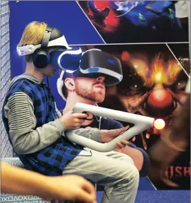  ??  ?? VISIONARIE­S: At the gaming expo, virtual reality games were played and enjoyed by many. There were many virtual gunfights.