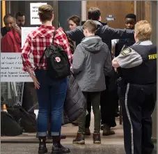  ?? CP PHOTO ?? Visitors pass through security as they attend Federal Court for a hearing to determine whether deportatio­n proceeding­s should be halted for Abdoul Abdi, the former child refugee, in Halifax on Thursday.