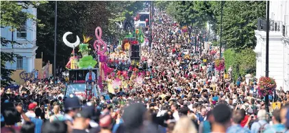  ??  ?? Crowds throng the streets of Notting Hill, west London, during the 50th year of the famous annual carnival