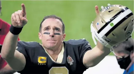  ?? Brynn Anderson, The Associated Press ?? Saints quarterbac­k Drew Brees gestures to his family and fans after an NFL divisional round playoff loss to the Tampa Bay Buccaneers on Sunday in New Orleans.