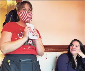  ?? Sarah Kyrcz/Hearst Connecticu­t Media ?? Brownstone House Family Restaurant waitress Courtenay Cooper clutches a breakfast bill, complete with a with a generous Christmas tip as customer Natalie Turcio looks on.