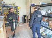  ?? RICARDO B. BRAZZIELL/AMERICAN-STATESMAN ?? Lazaro Martinez talks with Angie Cornwall as he restocks supplies for a Manor EMS crew Thursday.