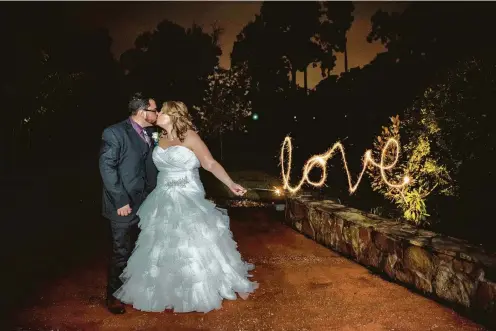  ?? Photos by Thai Hoang for Studio Htown ?? Meaghan Ryan and Brandon Romero tied the knot at Madera Estates in Conroe. “It looks like a postcard,” Meaghan says of this prized photograph.