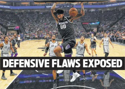  ?? Rich Pedroncell­i / Associated Press ?? Sacramento’s Willie Cauley-Stein goes in for an unconteste­d dunk Monday. The Kings encountere­d little resistance from the Spurs all night, shooting 50 percent.