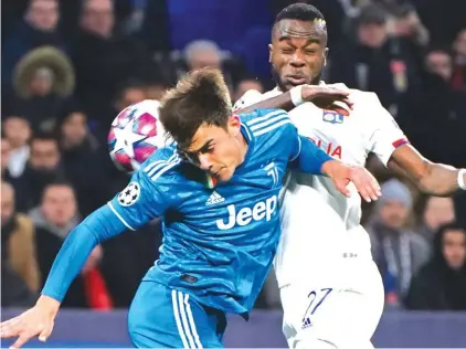  ??  ?? Juventus’ Paulo Dybala, left, and Lyon’s Maxwel Cornet jump to head the ball during a round of 16, first leg, match between Lyon and Juventus at the at the Lyon Olympic Stadium. Photo: AP