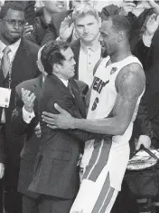  ?? DAVID SANTIAGO dsantiago@miamiheral­d.com ?? Coach Erik Spoelstra and LeBron James hug in Miami near the end of Game 5 of the NBA Finals against Oklahoma City on June 21, 2012. Miami won the series 4-1.