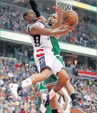  ?? [ALEX BRANDON/THE ASSOCIATED PRESS] ?? Bradley Beal of the Wizards tries to get a shot off as the Celtics’ Al Horford goes for the block in the first half.