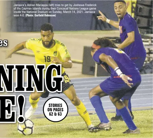  ?? (Photo: Garfield Robinson) ?? Jamaica’s Adrian Mariappa (left) tries to get by Joshewa Frederick of the Cayman Islands during their Concacaf Nations League game inside the National Stadium on Sunday, March 14, 2021. Jamaica won 4-0.