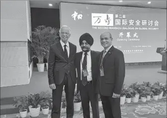  ?? PROVIDED TO CHINA DAILY ?? Surasit (right) attends the second Wanshou Dialogue on Global Security in Beijing in July 2019.