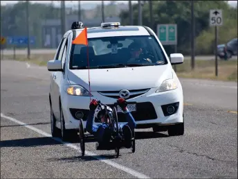  ?? ?? Handcyclis­t Brent Worrall on the outskirts of Swift Current at the start of a 400-kilometre journey to Humboldt, Sept. 7. The support vehicle is driven by his wife Gisela.