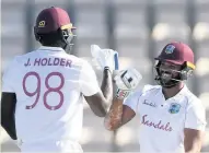  ??  ?? HISTORIC WIN Jason Holder, left, and John Campbell