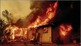  ?? ETHAN SWOPE — THE ASSOCIATED PRESS, FILE ?? Flames consume a house near Old Oregon Trail as the Fawn Fire burns about 10 miles north of Redding in Shasta County on Sept. 23. Officials have lifted all evacuation orders after crews made great progress corralling the wildfire.