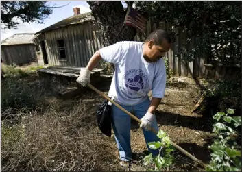  ?? NATHAN W. ARMES — SPECIAL TO THE DENVER POST, FILE ?? Windsor resident Lonnie Rodgers helps clean up the small community of Dearfield in 2008. Nature and human neglect had left the remaining structures of the historic Black settlement in serious disrepair. It is on the National Register of Historic Places.