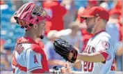  ?? Jayne Kamin-Oncea Getty Images ?? BUD NORRIS, with catcher Martin Maldonado, has 15 saves in 16 opportunit­ies for the Angels.