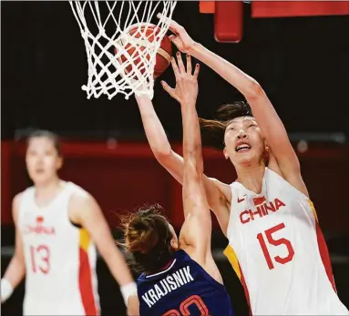  ?? Charlie Neibergall / Associated Press ?? China’s Han Xu (15) shoots over Serbia’s Tina Krajisnik during a quarterfin­al game at the 2020 Summer Olympics in 2021 in Saitama, Japan.