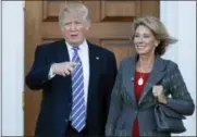  ?? CAROLYN KASTER — THE ASSOCIATED PRESS FILE ?? In this file photo, President-elect Donald Trump stands with Education Secretary-designate Betsy DeVos in Bedminster, N.J. DeVos is widely expected to push for expanding school choice programs if confirmed as education secretary, causing outrage among...