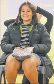  ?? ?? ALL SMILES: Jessi Toet, seated in front of her school classmates, shows off the hair she will donate to people with cancer and alopecia.