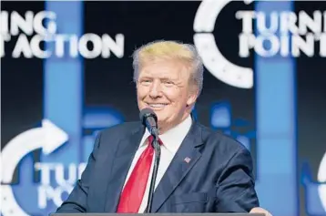  ?? ROSS D. FRANKLIN/AP ?? Former President Trump talks to supporters July 24 at a Turning Point Action gathering in Phoenix. As he mulls a comeback run in 2024, Trump has been wading into local secretary of state and attorney general races in key swing states.