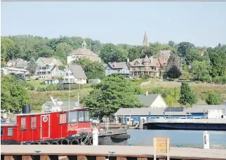  ?? PHOTOS BY WAYNE NEWTON/FOR POSTMEDIA NEWS ?? The view of the harbour and village buildings from the pier is among the many pretty scenes in Bayfield, Wisc. From here, boats take tourists to the Apostle Islands.