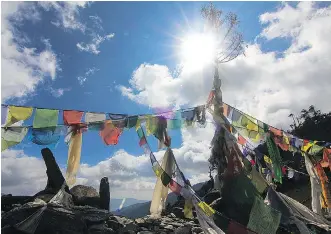  ??  ?? A sight in Nepal that few outsiders ever see: prayer flags fluttering in the breeze above the Lamjura Pass.