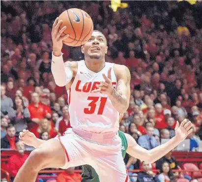  ?? ROBERTO E. ROSALES/JOURNAL ?? UNM’s Troy Simons focuses on the basket while driving for a layup during Saturday night’s 80-65 victory over Colorado State. Simons scored 13 points in 17 minutes for the Lobos.