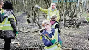  ??  ?? ●● Children from Broadhurst Primary working at Moston Fairway in a Forest School run by The Wildlife Trust