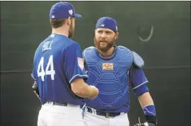  ?? Morry Gash Associated Press ?? RUSSELL MARTIN talks with Rich Hill during a spring-training workout in Arizona. Martin will divide catching duties this season with Austin Barnes.