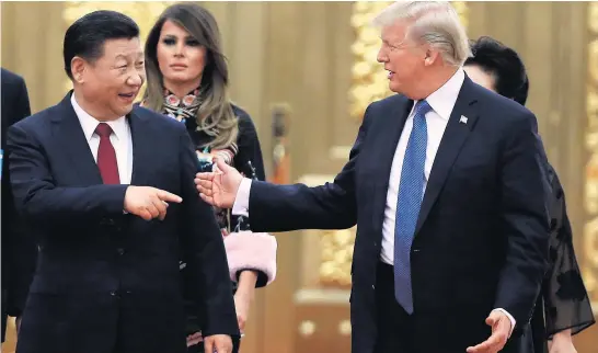  ?? Picture / AP ?? Xi Jinping and Donald Trump share a joke as they head to a state dinner with their wives in Beijing.