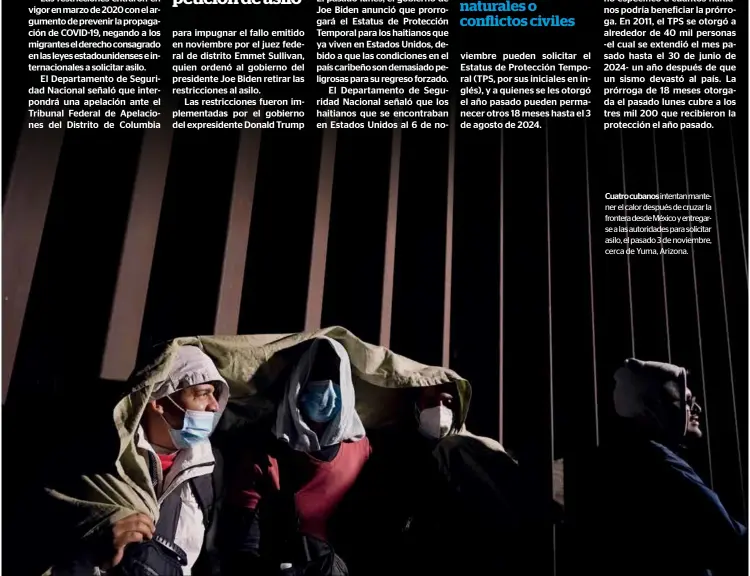  ?? ?? Cuatro cubanos intentan mantener el calor después de cruzar la frontera desde México y entregarse a las autoridade­s para solicitar asilo, el pasado 3 de noviembre, cerca de Yuma, Arizona.