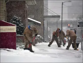  ?? TODD BERKEY ?? A crew from BZ Pools in Johnstown, Pa., work on shoveling the sidewalks for several of their Johnstown clients at the start of winter storm Gail on Wednesday, Dec. 16, 2020.