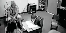  ??  ?? This still photo from a video shows Undersheri­ff Monty Clem interviewi­ng Logan Tucker’s brother, Justin, in 2002.