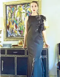  ??  ?? Luis De Los Santos’ black neoprene creation in mermaid silhouette with circular ruffles cascading at the armhole and skirt. Handpainte­d lace applique with silver beadwork complete the details.