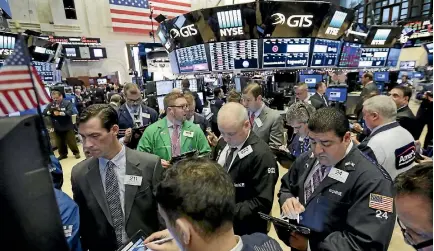  ??  ?? Traders on the floor of the New York Stock Exchange in New York. Financial services have overtaken manufactur­ing as the largest industry in the US.