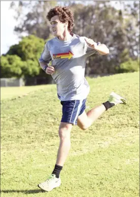  ??  ?? PHOTO BELOW: Quinn Shapiro sprints on the final lap on his way to winning the boys U-18 race.