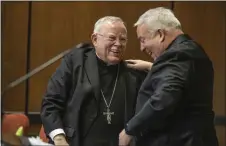  ?? ASSOCIATED PRESS ?? Archbishop Charles J. Chaput, left, and Archbishop-elect Nelson J. Perez, right, share a happy moment after they embraced during the press conference announcing Perez as the Archbishop-elect of Philadelph­ia on Thursday.