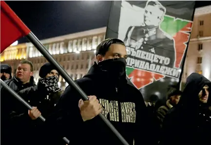  ?? PHOTO: AP ?? Bulgarian nationalis­ts’ supporters march holding flags and portrait of General Lukov during annual Lukov march in Sofia.