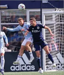  ?? STAFF PHOTO BY STUART CAHILL — BOSTON HERALD ?? FC Dallas forward Paul Arriola and New England Revolution midfielder Matt Polster, right, jump to head the ball during a March 3 game in Foxboro.