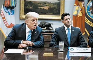  ?? EVAN VUCCI/AP ?? House Speaker Paul Ryan, R-Wis., showed the president glossy photos of a wall being built along the U.S.-Mexico border.