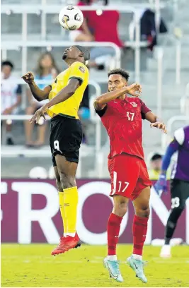  ?? AP ?? Jamaica forward Cory Burke (left) and Guadeloupe defender Anthony Baron go for a head ball during the second half of a Concacaf Gold Cup Group C football match on Friday, July 16, 2021, in Orlando, Florida.