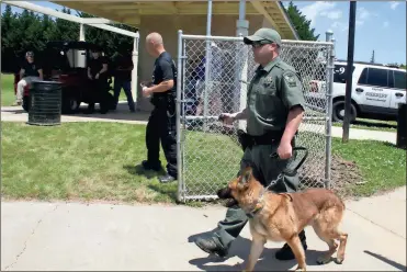  ??  ?? Diane Wagner / RN-T
Deputy Matthew Lane of the Madison County (Ala.) Sheriff’s Office brings his K9 onto the field at Riverview Park for the suspect search phase of the regional U.S. Police Canine Associatio­n certificat­ion tests hosted by the Rome...