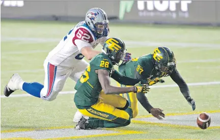  ?? THE CANADIAN PRESS ?? Montreal’s Jake Piotrowski (No. 62) tries to beat Edmonton’s John Ojo (No. 26) and Otha Foster (No. 37) to a loose ball after backup quarterbac­k Tanner Marsh fumbled on the Edmonton two-yard-line in the second half. It was the most damaging of five...