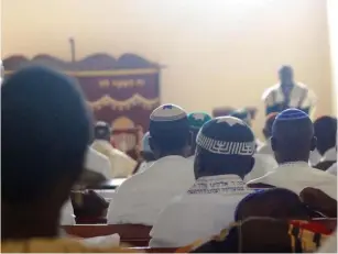  ??  ?? Members of the Ugandan Jewish community praying in synagogue.