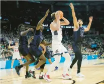  ?? WARREN/AP
TED S. ?? Saint Mary’s center Mitchell Saxen, second from right, is pressured by Grand Canyon’s Lok Wur, from left, Tyon Grant-Foster and Gabe McGlothan during the second half Friday in Spokane, Washington.