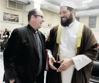  ?? REBECCA WRIGHT/ The Windsor Star ?? Rev. Kevin George, left, and Imam Shaikh Mohamed Mahmoud chat before a Christian-Muslim event
at Windsor Mosque on Sunday. ‘Some come with fear, but they leave with love,’ Mahmoud says.