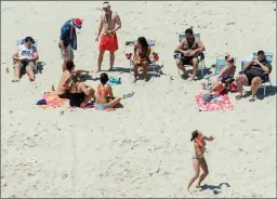  ?? The Associated Press ?? New Jersey Gov. Chris Christie, right, uses the beach with his family and friends at the governor's summer house at Island Beach State Park in New Jersey. Beaches were closed to the public during New Jersey’s government shutdown.