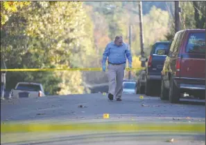  ??  ?? CRIME SCENE SEARCH: Hot Springs police Detective Less Jessup investigat­es the scene of shots fired on Greenway Street on Wednesday afternoon following an alleged altercatio­n between a tenant and her landlords.