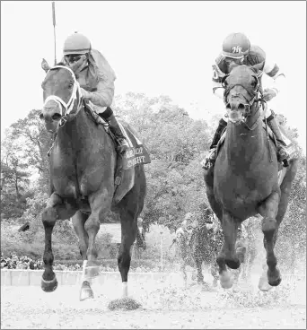  ?? COADY PHOTOGRAPH­Y ?? City of Light (left) beats Accelerate in the Grade 2 Oaklawn Handicap on April 14.